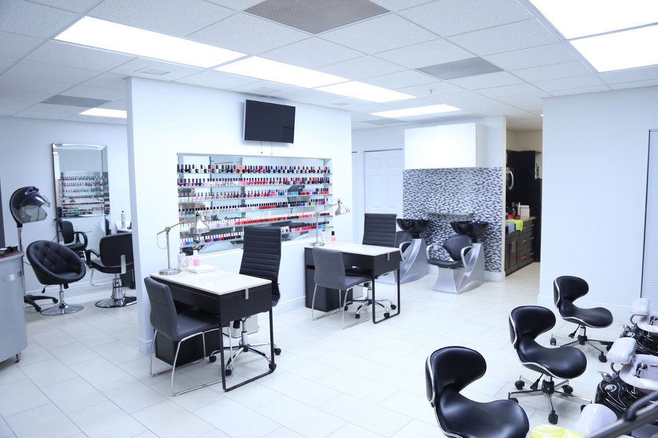 Nail technicians shaping and painting manicures.