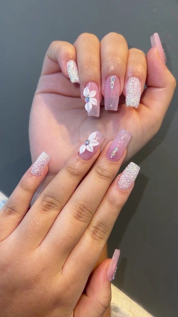 Nail technicians shaping and painting manicures.
